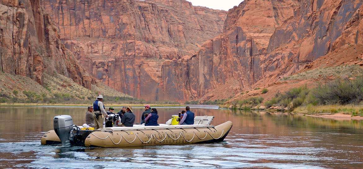 Several people aboard a raft on the Colorado River