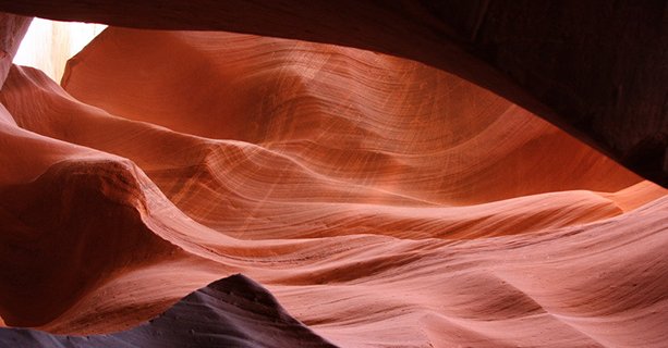 Red sandstone walls within Antelope Canyon.