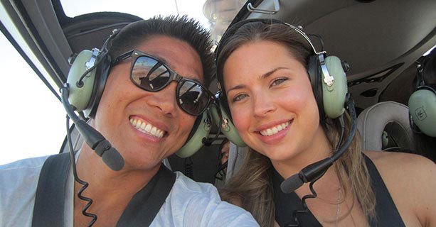 Two guests aboard an EC-130 helicopter during a tour.