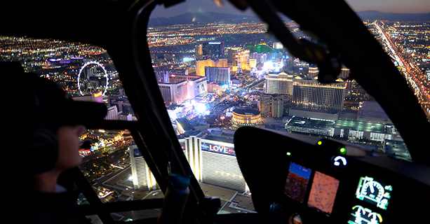 A pilot navigates a helicopter over the Las Vegas Strip.