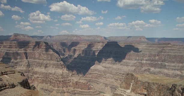 The sun casting shadows across the Grand Canyon walls.