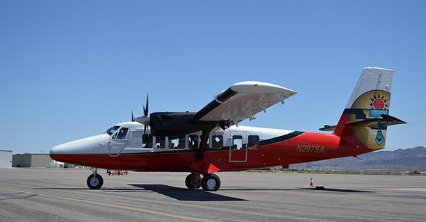 A Twin Otter airplane parked on a tarmac.