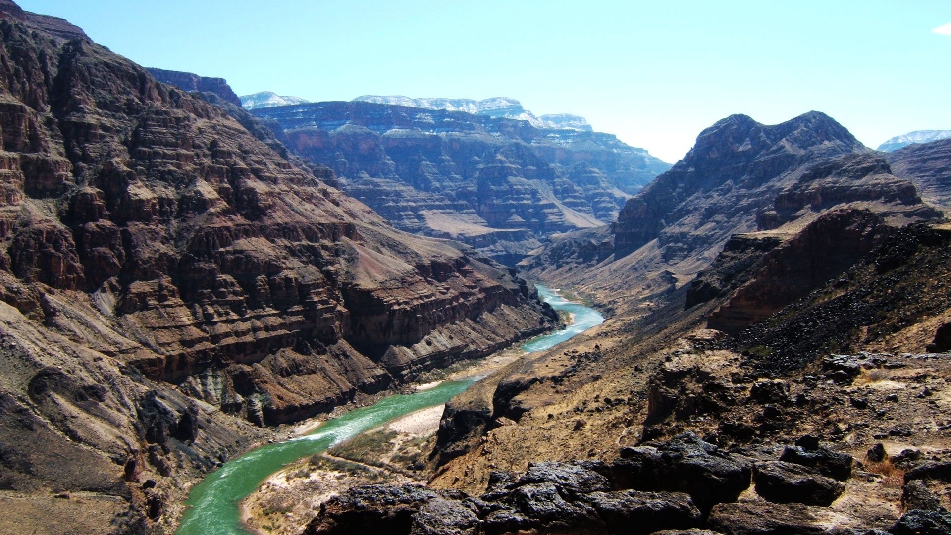 A rugged region of the Grand Canyon with the Colorado River cutting through.