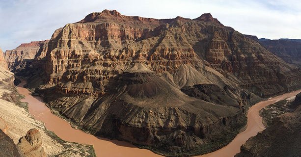 A panoramic landscape of the Grand Canyon and the Colorado River.