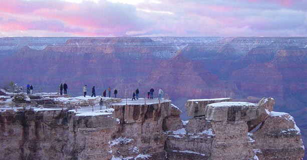 Guests visiting Grand Canyon during winter with snow on the canyon