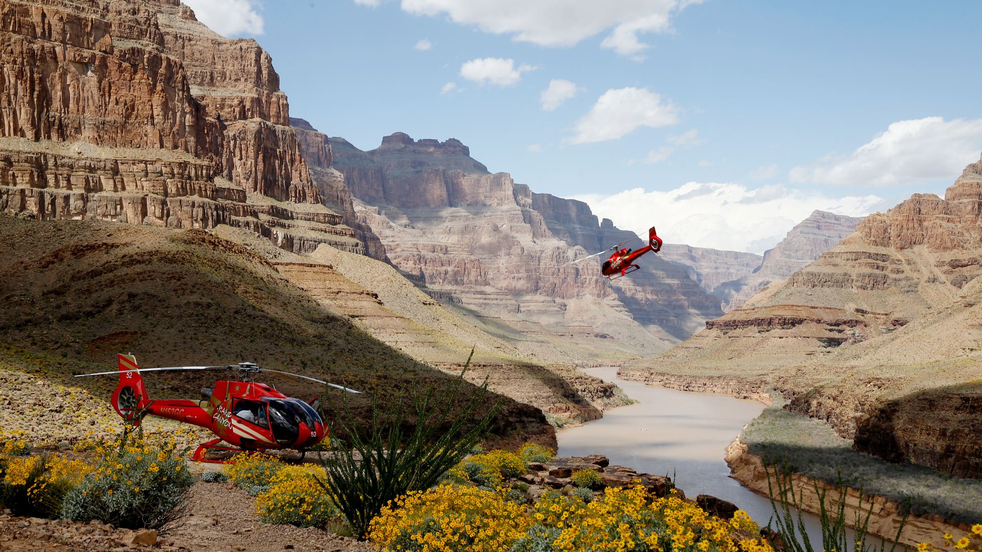 Two helicopters landing at the bottom of the Grand Canyon West.