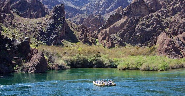 Guests on a raft exploring the banks of the Colorado River.