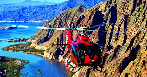 A helicopter soars over the Arizona desert and the Colorado River.