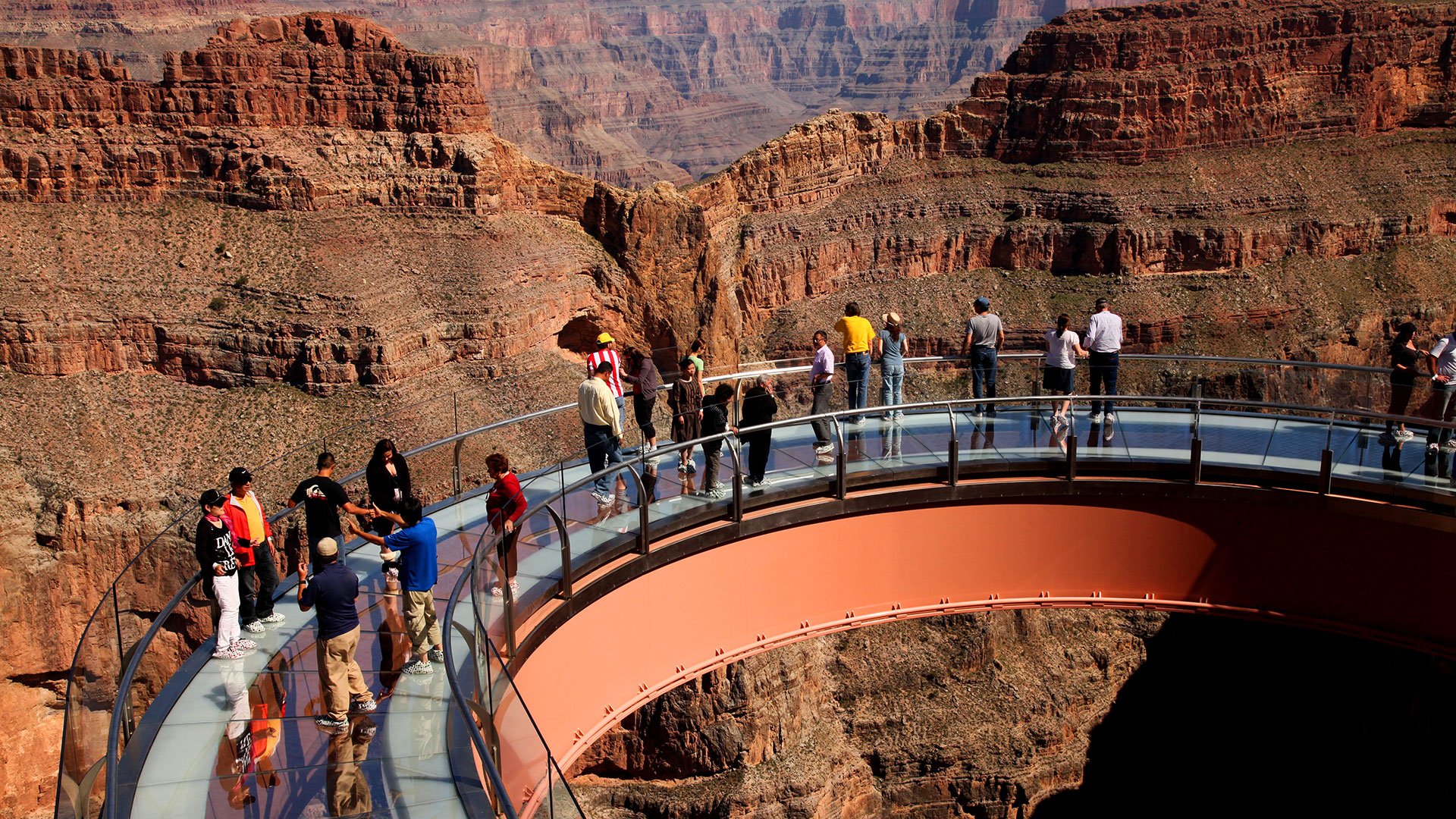 Visitors on the Skywalk glass bridge with a full view of the Grand Canyon West Rim.