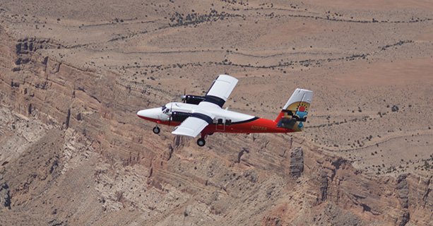A Grand Canyon airplane tour soars over the desert landscape.