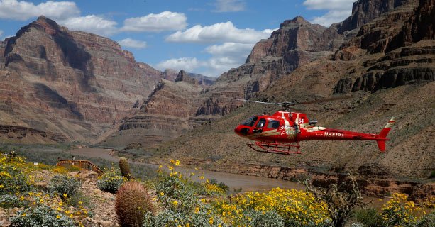 A helicopter descends to the bottom of the Grand Canyon West Rim.