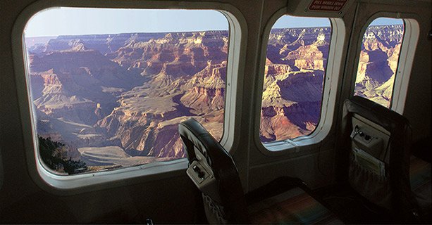 An aerial view of the Grand Canyon seen from the window of an airplane.