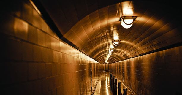 A dimly-lit hallway within the Hoover Dam's interior.