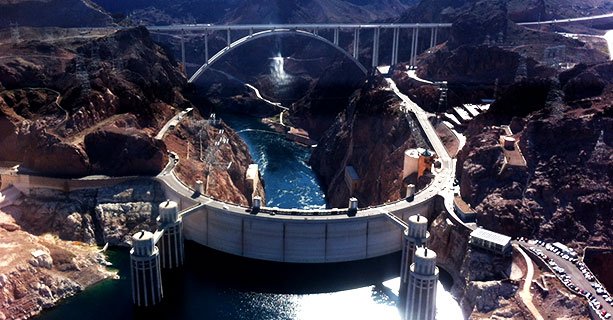 The Hoover Dam as seen from behind with the O'Callaghan-Tillman Memorial Bridge behind it.