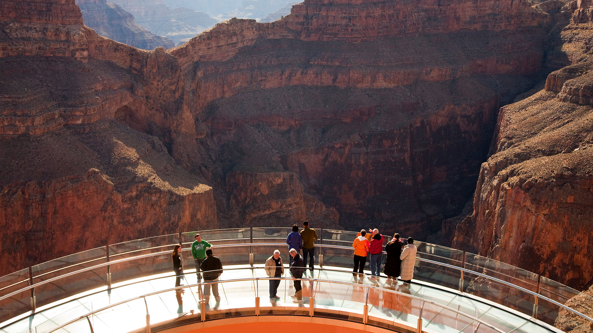 Guests looking through the glass floor of the Skywalk Bridge at the Grand Canyon West.