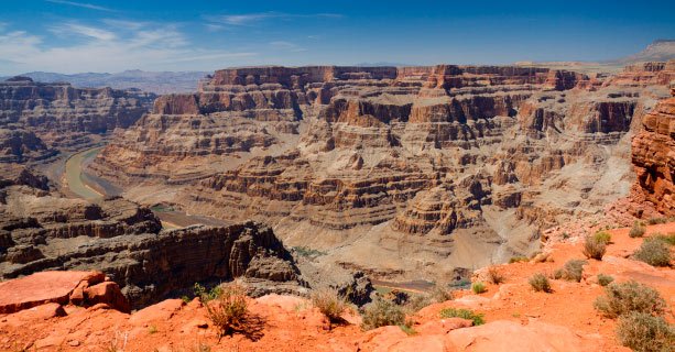 A scenic panorama of the Grand Canyon West with the Colorado River below.