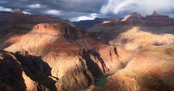 The Grand Canyon National Park lit by partly cloudy skies.