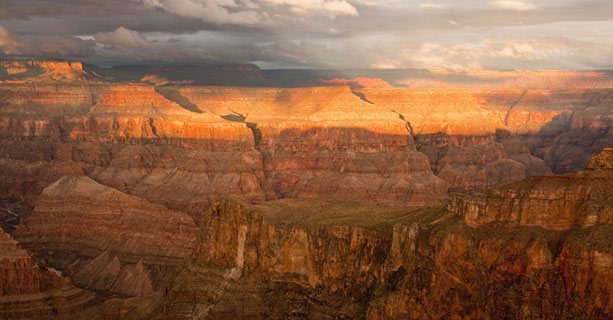 The sun sets across a Grand Canyon landscape.