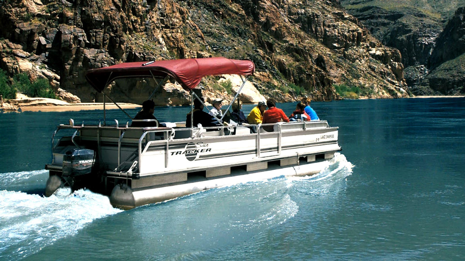 Passengers aboard a pontoon boat floating up the Colorado River at Grand Canyon West.