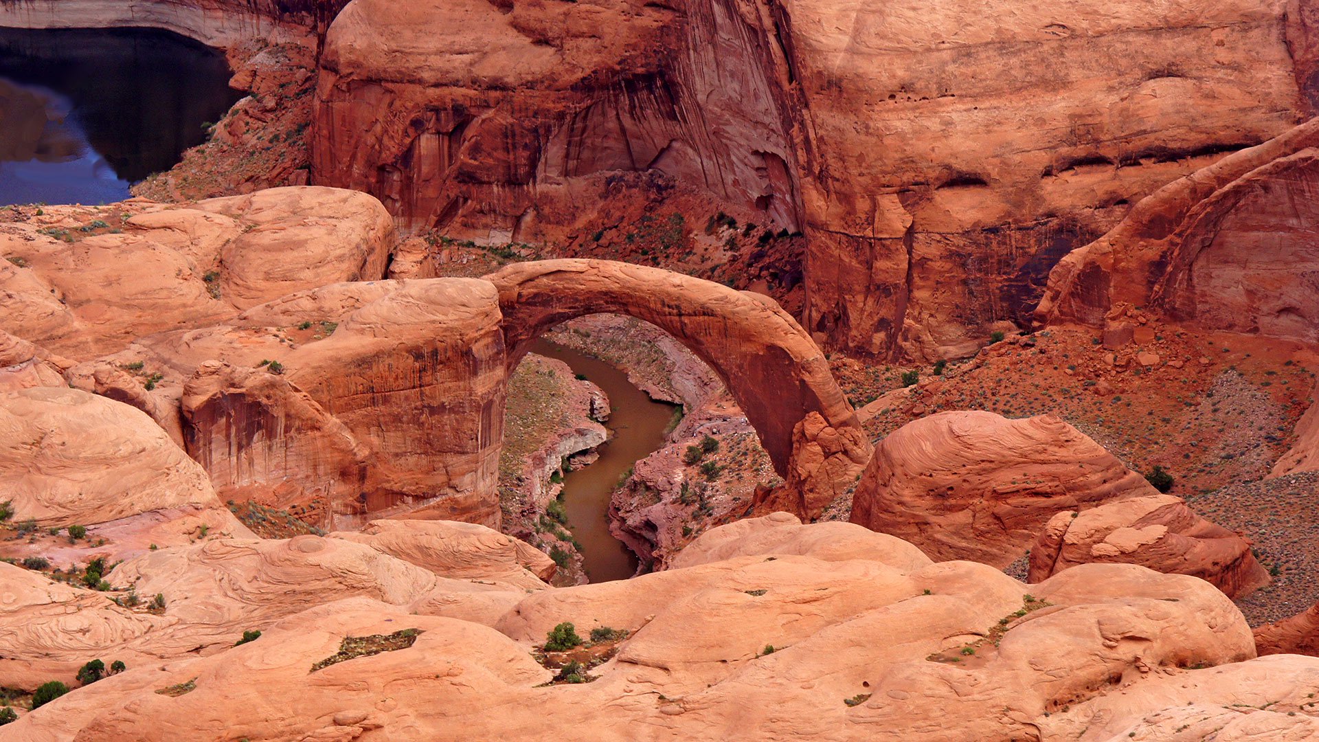 Scenic view of Rainbow Bridge surrounded by desert scenery.