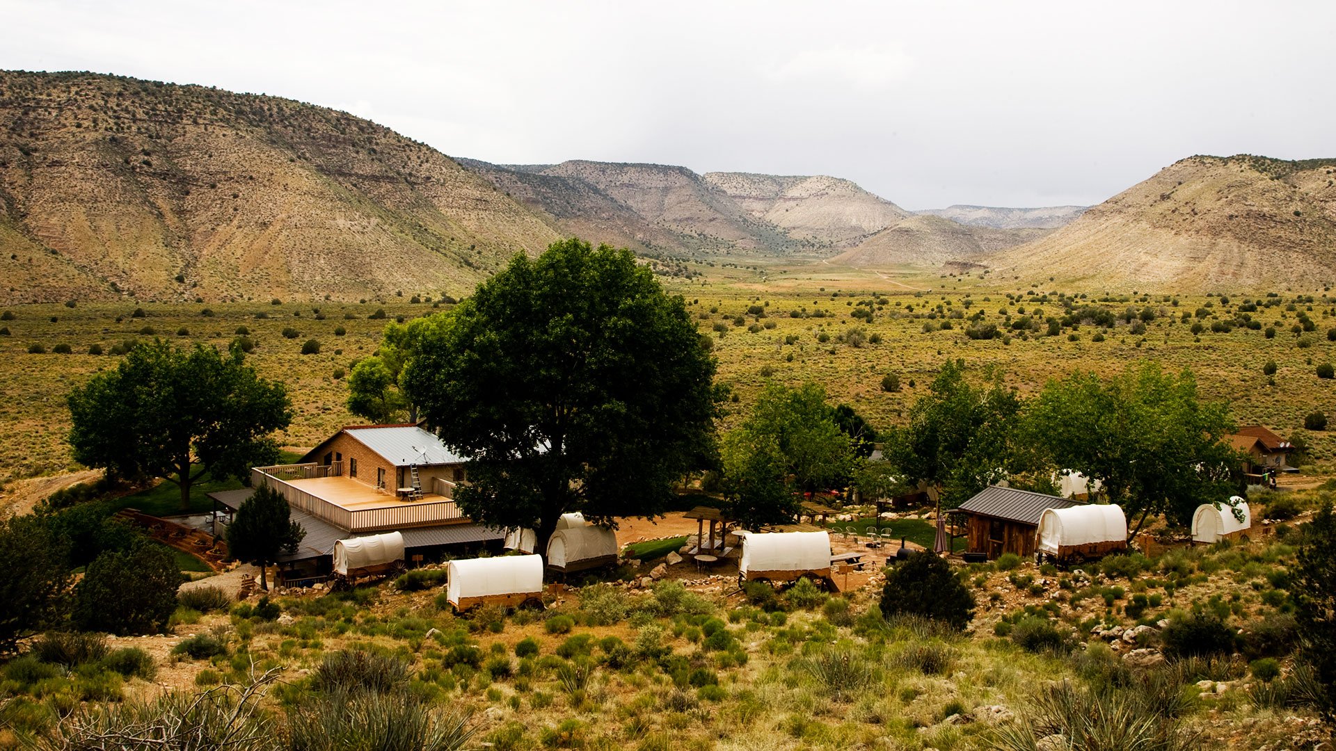 A view of Bar 10 Ranch, their covered wagons, and the surrounding nature.