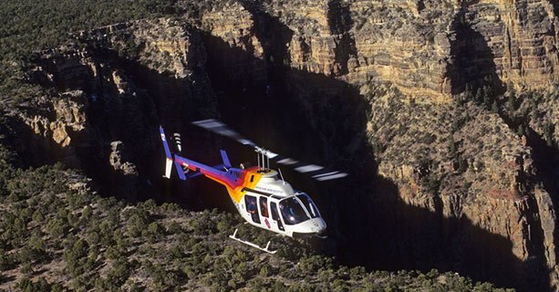 Bell helicopter flies over the Grand Canyon.