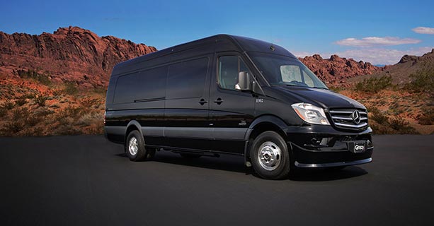 A Sprinter vehicle parked in front of Nevada desert scenery.