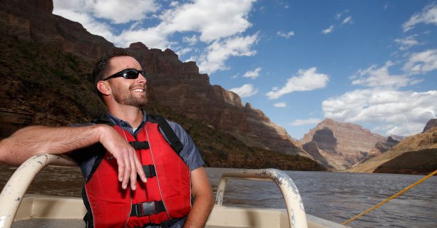 A passenger aboard a pontoon board on the Colorado River.