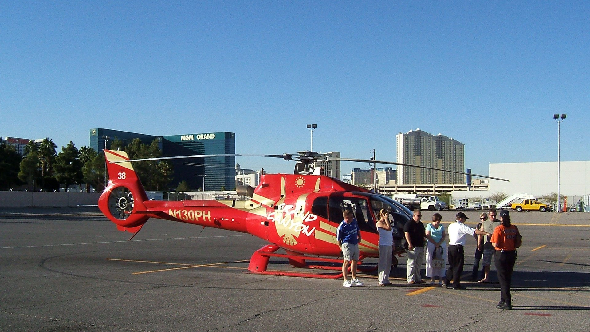 Passengers preparing to board their helicopter tour with the Las Vegas Strip in the background.