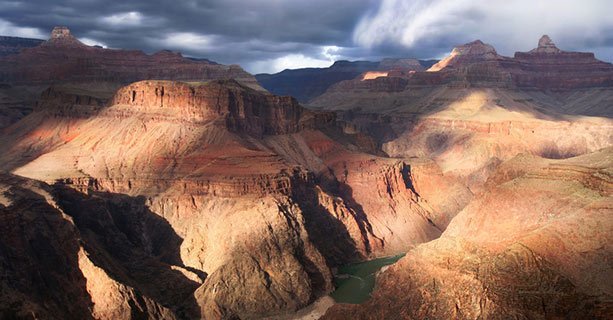 The sun casts shadows across the walls of the Grand Canyon.