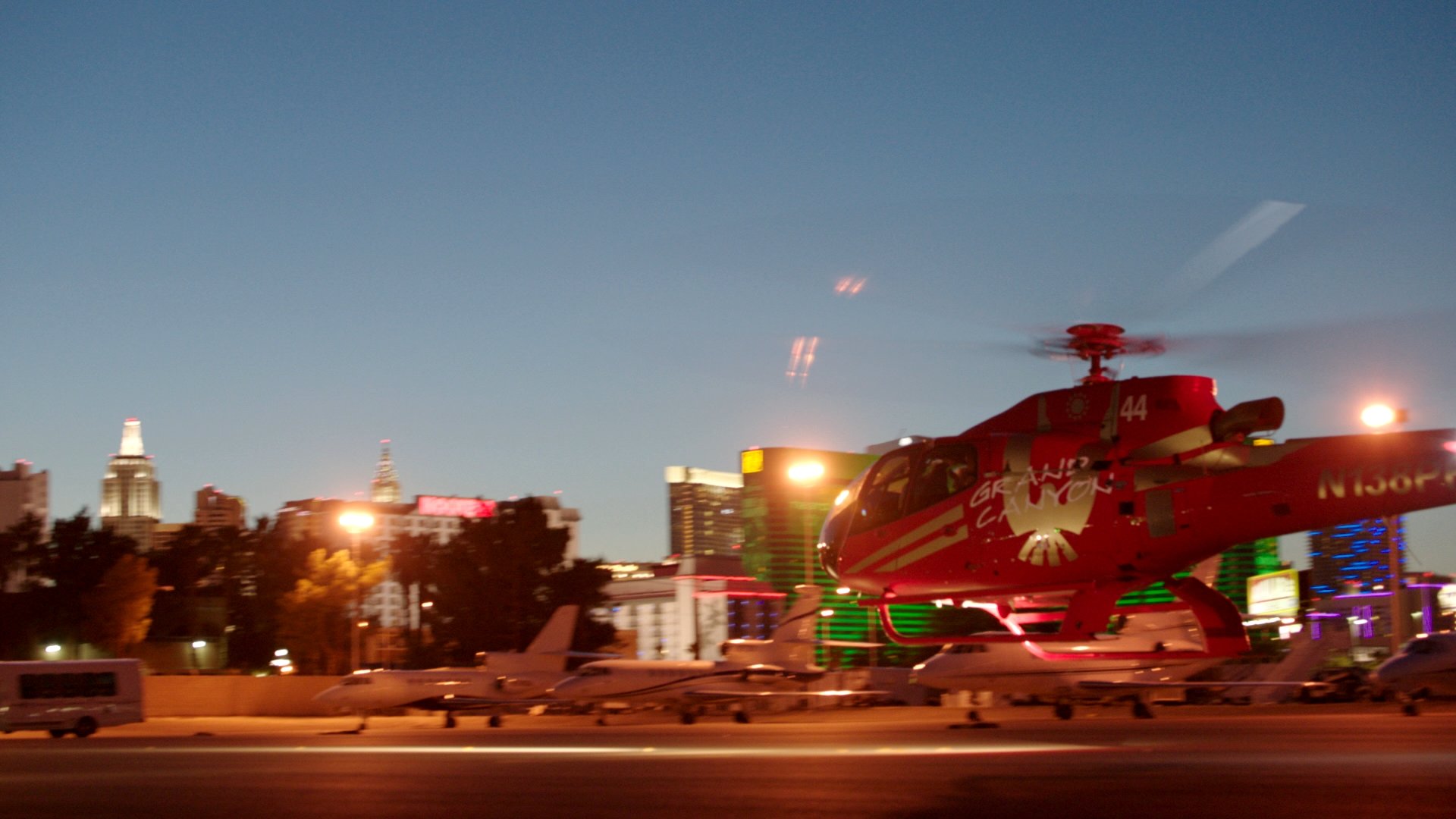 A helicopter setting off on a Las Vegas Strip tour at night.