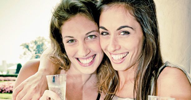 Two passengers toasting champagne before their Las Vegas helicopter tour.