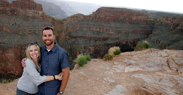 Sightseers pose for a picture at the edge of the Grand Canyon West.