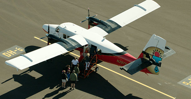 Passengers board a Twin Otter aircraft.