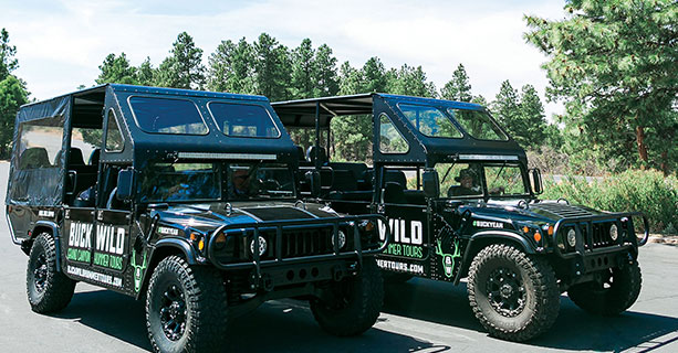 Two open-air style Hummer vehicles.