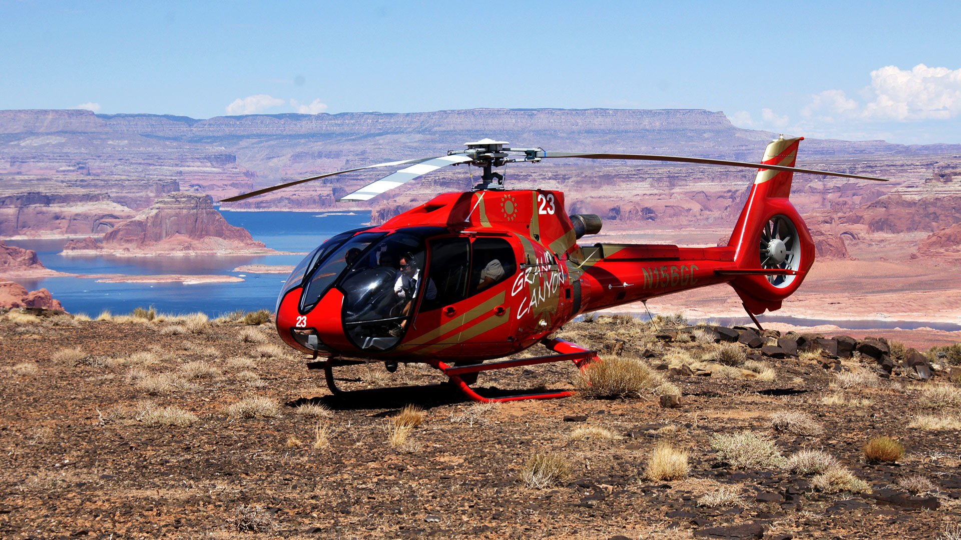 EC-130 landed atop Tower Butte with Lake Powell in the background.