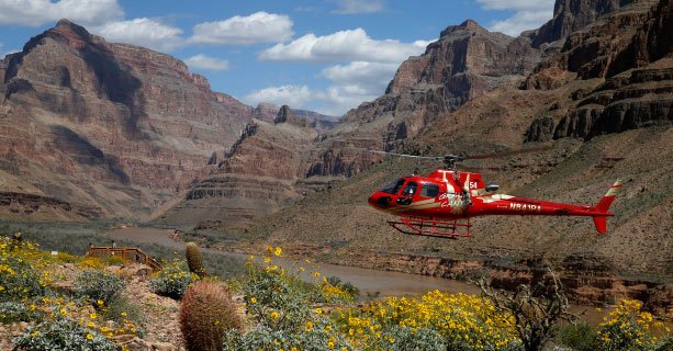 A helicopter makes a descent to the floor of the Grand Canyon West.