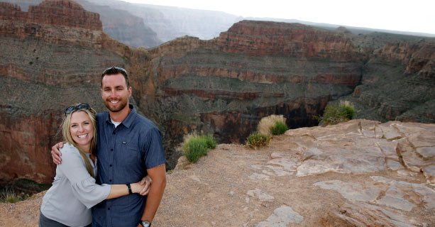 A couple hugs at the edge of the Grand Canyon.